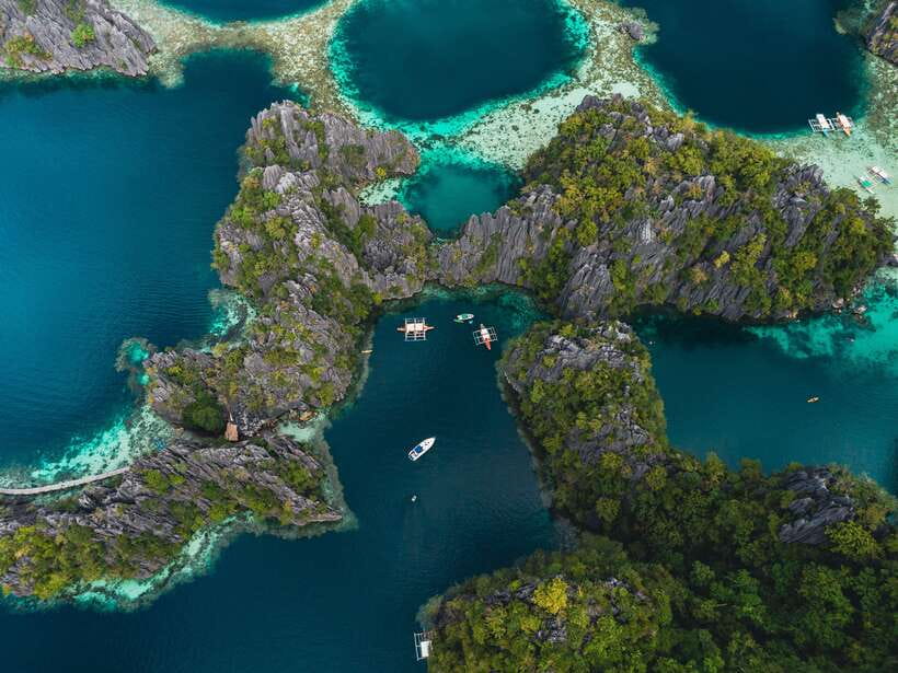 Coron: Private Island-Hopping Tour on a Yacht or Speedboat - Barracuda Lake and the water below the cliffs