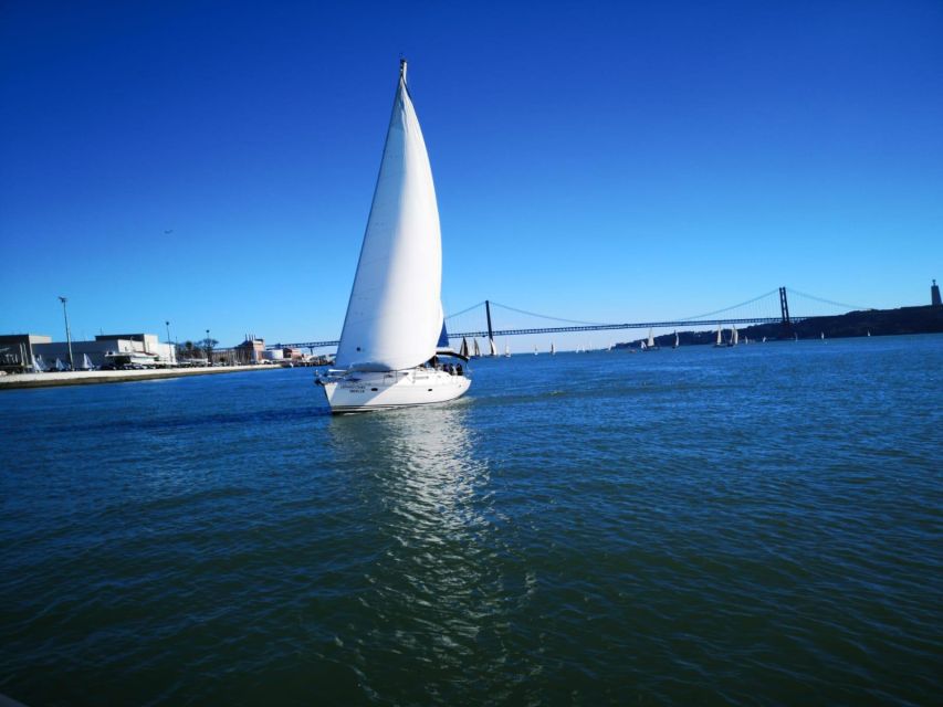 Lisbon: Yacht Sailing Tour With Portuguese Wine and History - Leaving Doca de Santo Amaro beneath the bridge