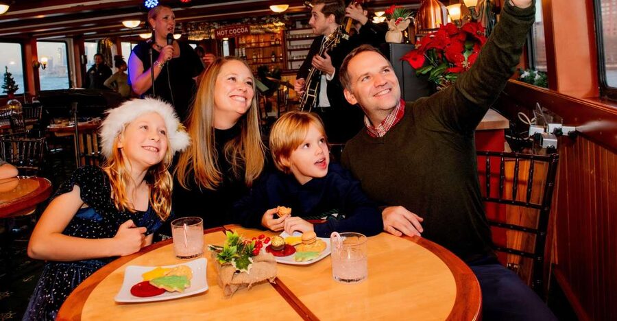 NYC: Holiday Yacht Cruise with Jazz, Cocoa & Carols - The Manhattan skyline from a warm salon