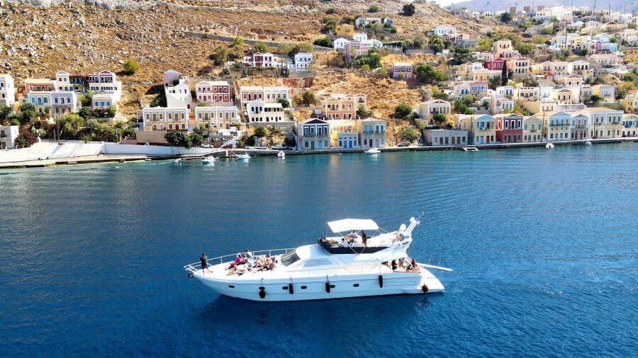 Rhodes: Symi Yacht Tour with Unlimited Drinks and Transfer - Entering Symi Town after the open-water crossing